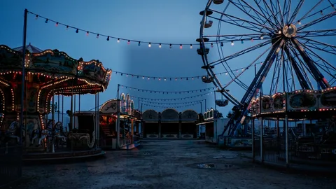 Fairground : a funfair lit up at dusk