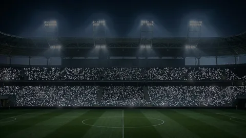 Stadium : a night stadium and lit-up phones